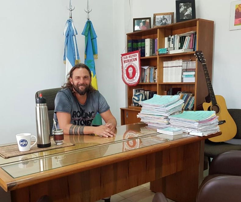 El juez Saettone en su despacho de Pilar, con la guitarra y el bander&iacute;n de Hurac&aacute;n.