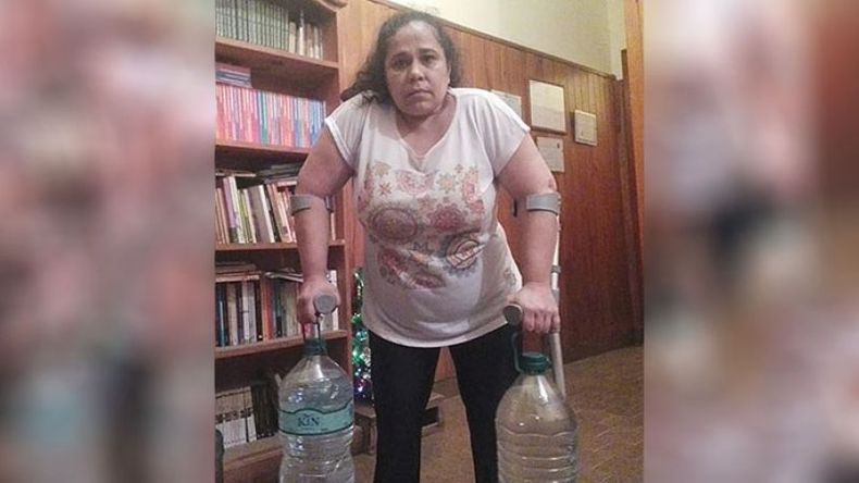 PROBLEMAS. Natalia acarreando dos bidones de agua. Lleva días sin servicio..