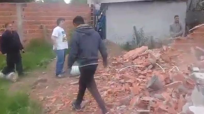 La policía da instrucciones a los jóvenes que demolieron la casa..