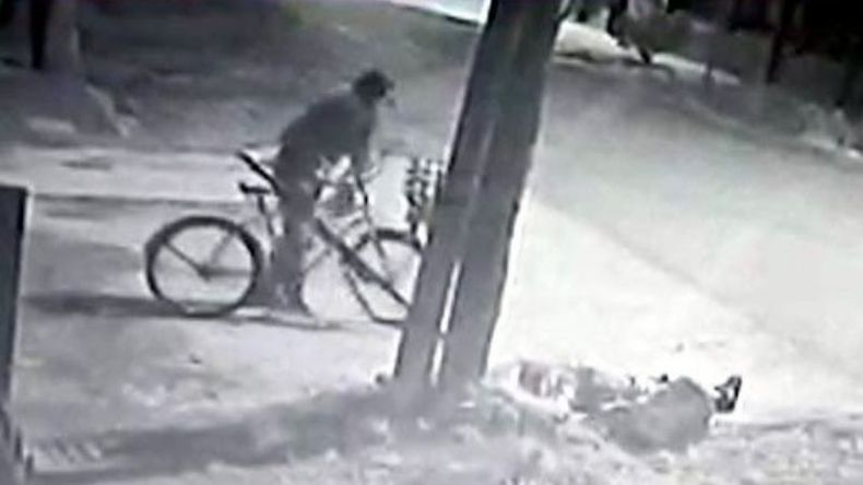 El repartidor con su bicicleta. En el suelo yace el ladrón..