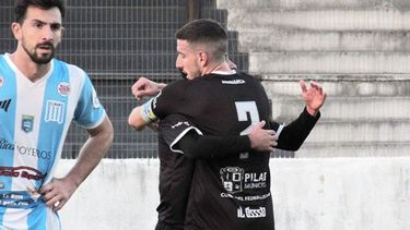 DOS CARAS. Diego Crego abraza a Santiago Tossi, autor de dos goles.Um defensor de Arenas lo sufre. (FOTO: PRENSA REAL PILAR)..