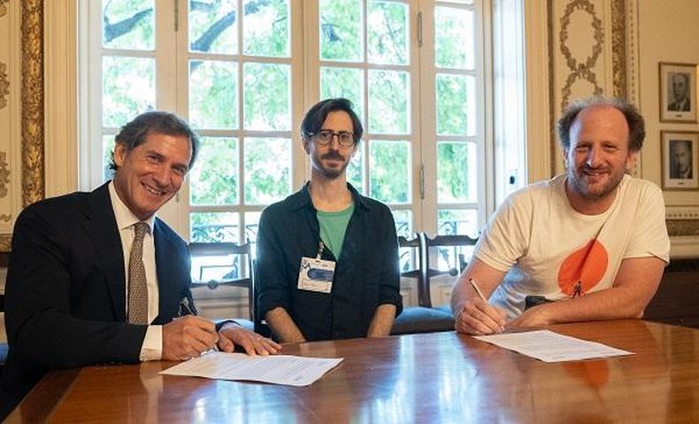 Santiago Bellomo, decano de la Escuela de Educación de la Universidad Austral, firma el acuerdo junto a Pablo Riera y Juan Kamienkowski, investigadores del Laboratorio de IA Aplicada de la UBA.