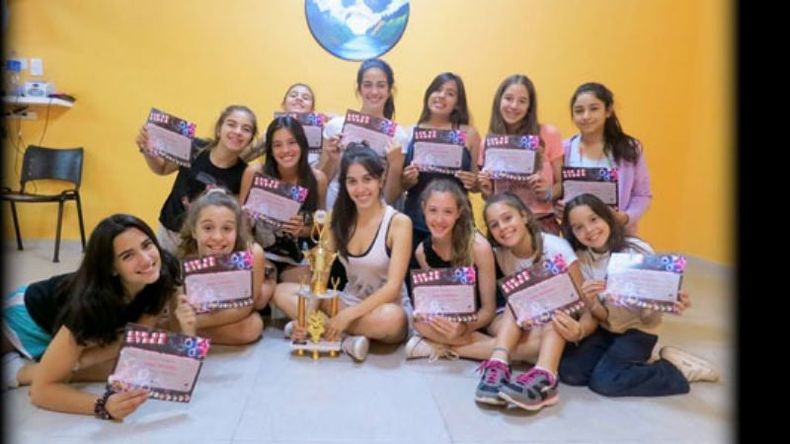 Mime Gorosito (centro) rodeada de sus alumnas. Todas muestran el premio obtenido en Tigre..