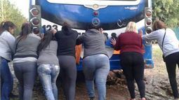Mujeres en acción. Vecinas y pasajeras rescatan el colectivo encajado en el barrio Carabassa. Foto Merry Franco..
