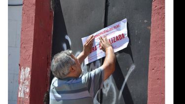 Inspectores municipales colocan las fajas en la obra paralizada..