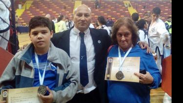 MEDALLISTAS. Barberena y Kaigar con sus preseas, custodiando a López..