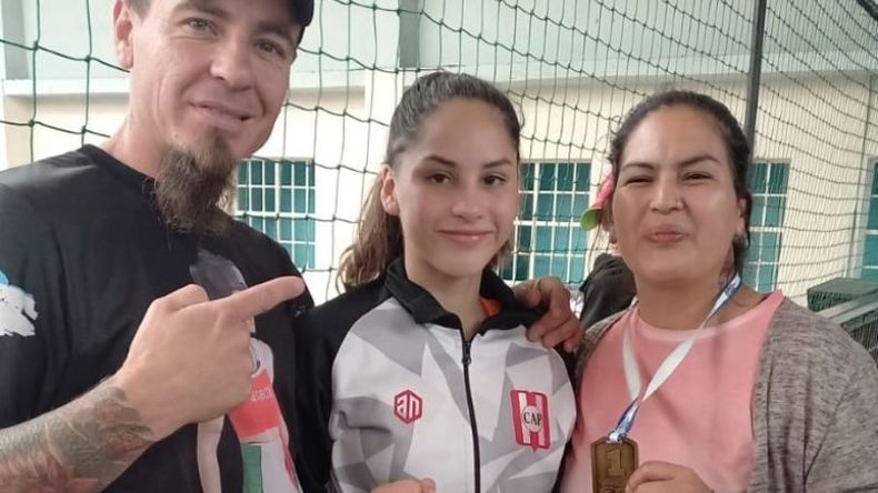 Celeste González celebra su medalla de oro en box junto a sus padres. .