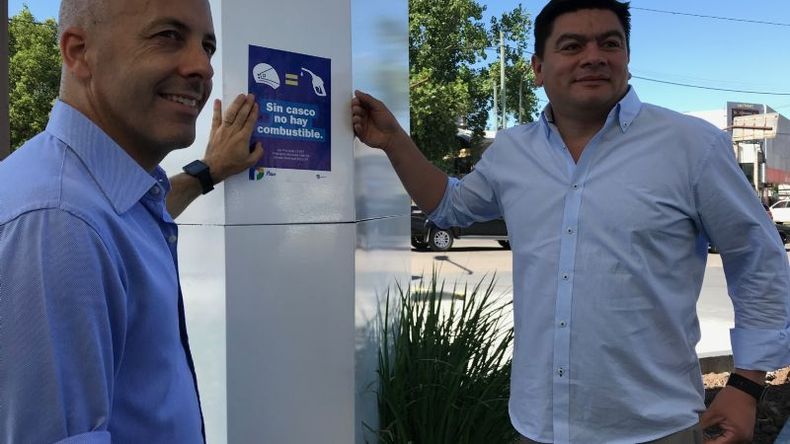De la mano. Ducoté y su reemplazante de verano, Miguel Gamboa, pegaron el cartel indicatorio en la YPF de ruta 8 y AV. Tratado del Pilar. .