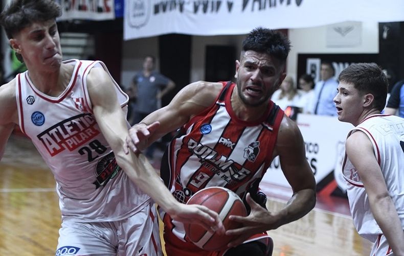 Atlético Pilar intenta frenar con Franco Ferri un ataque del goleador local, Fernández.