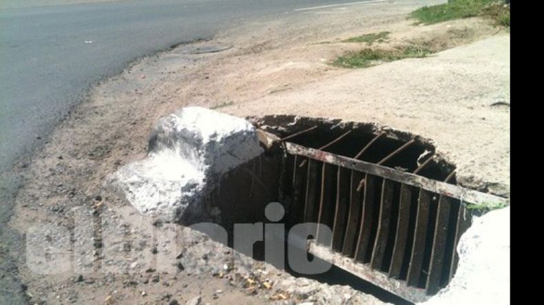 Ruta 8 e Ituzaingó. Una rejilla averiada y la tapa destruída por los vehículos..