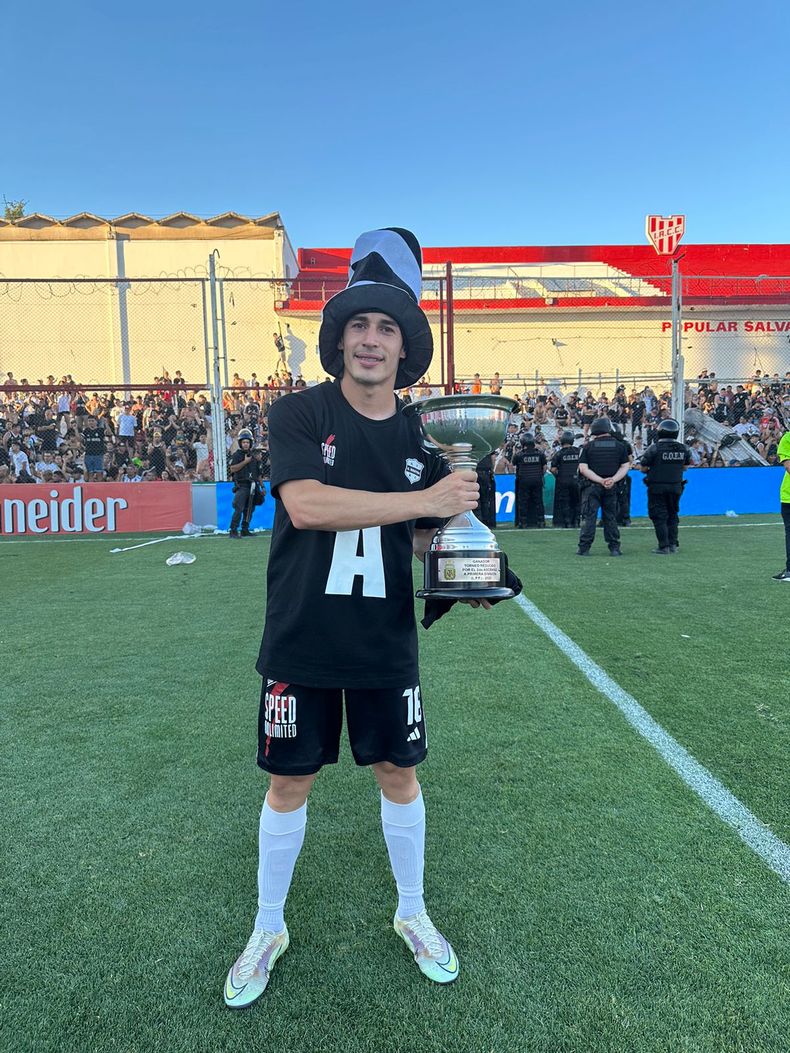 COPADO. La Mona Magallanes posa con la copa tras lograr el ascenso con Riestra en Córdoba.