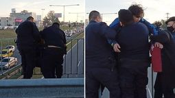 TENSIÓN. Momento en que los policías rescatan, por segunda vez al hombre que intentaba quitarse la vida..
