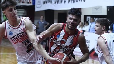 Atlético Pilar intenta frenar con Franco Ferri un ataque del goleador local, Fernández.